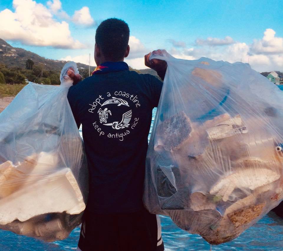 man holding trash bags