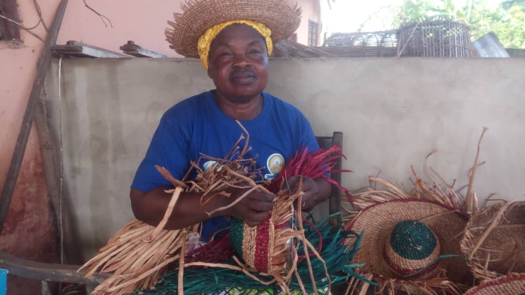 woman weaving a hat