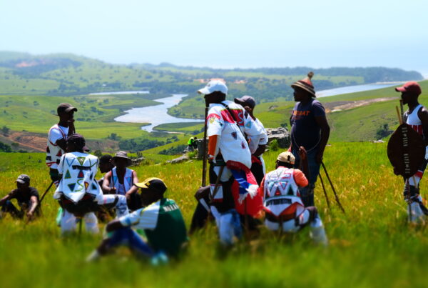 amaMpondo men preparing for a cultural celebration against the backdrop of a river mouth and the grassland-forest landscape mosaic