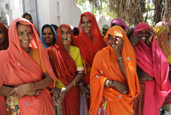 Women return from a monthly self-help group meeting, where members contribute to shared savings and discuss social concerns, working together to find fair solutions