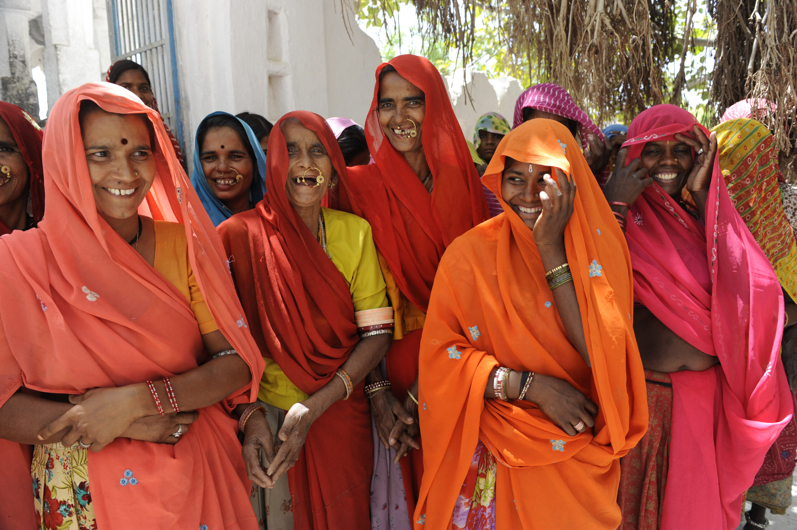 Women return from a monthly self-help group meeting, where members contribute to shared savings and discuss social concerns, working together to find fair solutions
