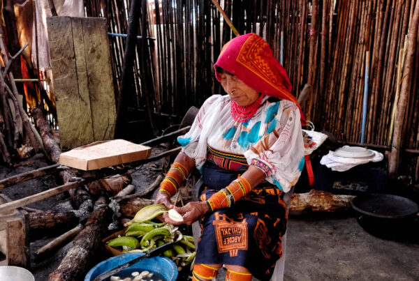 A woman from the Guna ethnic group is peeling bananas in her kitchen