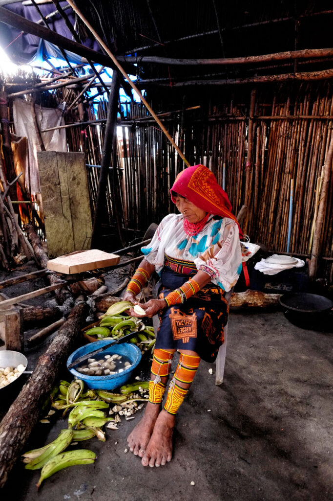 A woman from the Guna ethnic group is peeling bananas in her kitchen